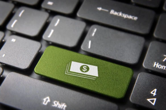 a key on a keyboard shows a symbol of a stack of cash.