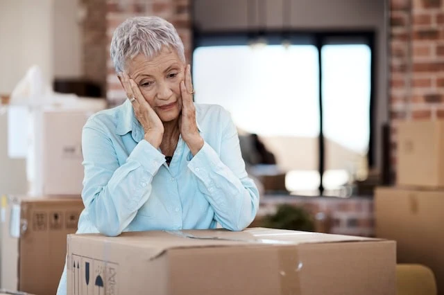 10 Useful Decluttering Tips for Retirees 3 elderly moving house boxes unhappy 640