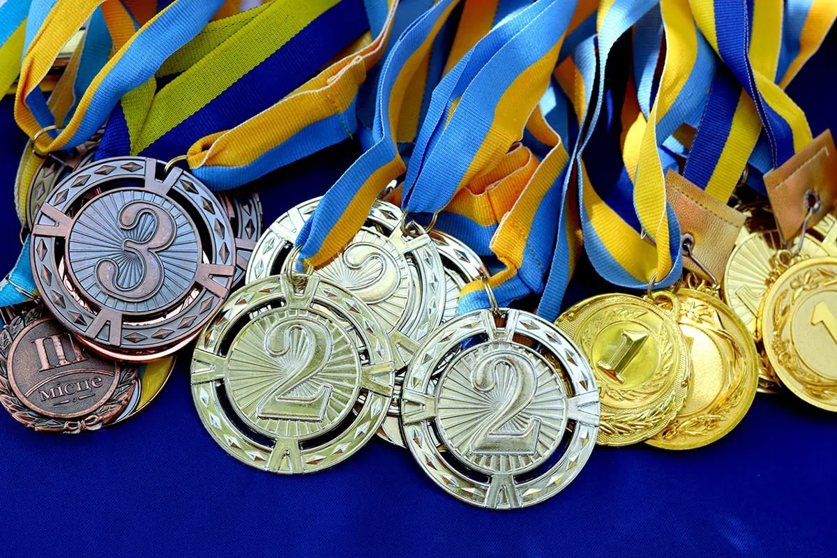 10 Best 'Rebound' Stocks to Buy for the Rest of 2026 2 a bunch of bronze silver and gold medals overlapping one another.