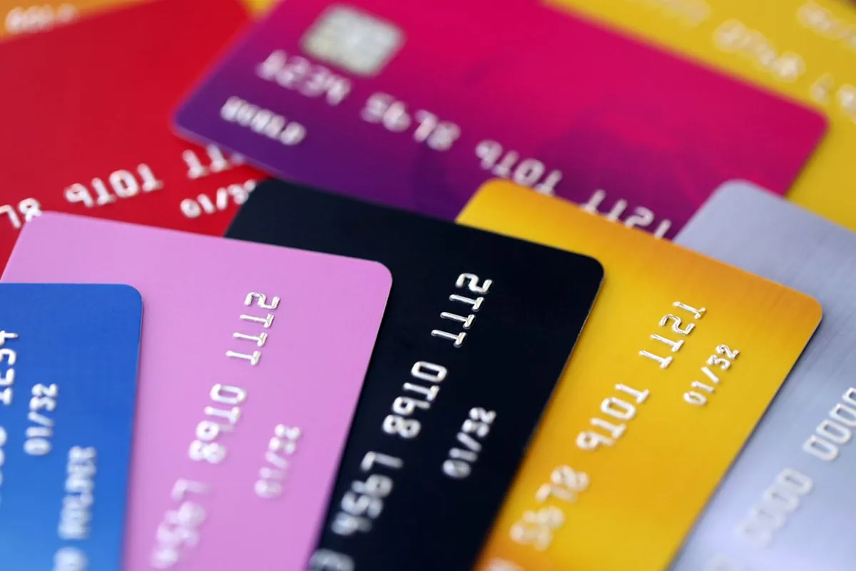 10% APR Cap on Credit Cards? Wall Street Says It’s Unlikely. 2 several credit cards of different colors.