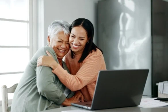 mother daughter financial caregiving laptop
