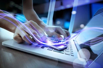 concept art of a purple light beam moving across a person's hand and onto their laptop.