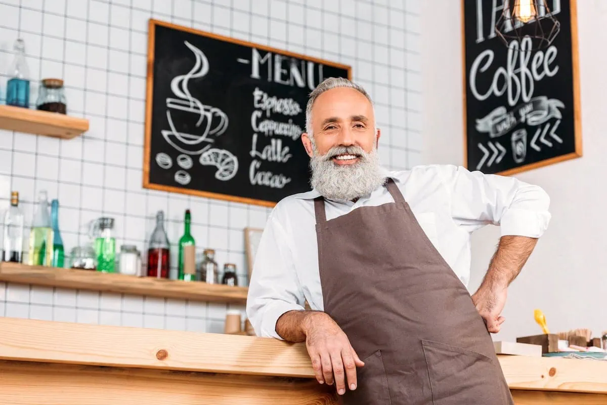 What Is FIRE? A Beginner's Guide to the Early Retirement Movement 11 a senior working at a cafe.