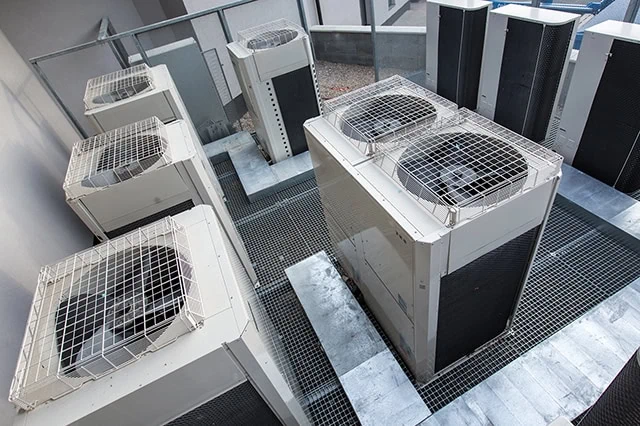 7 Best Growth Stocks to Buy for the Rest of 2026 20 Air conditioning equipment atop a modern building.