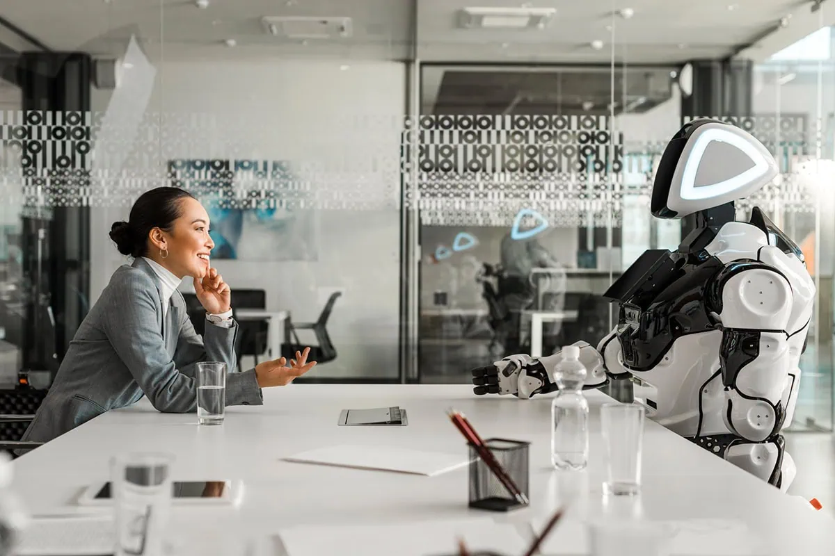 7 Space ETFs for the Next Frontier of Investing 4 Concept art of a robot talking to a person in a futuristic lab break room.