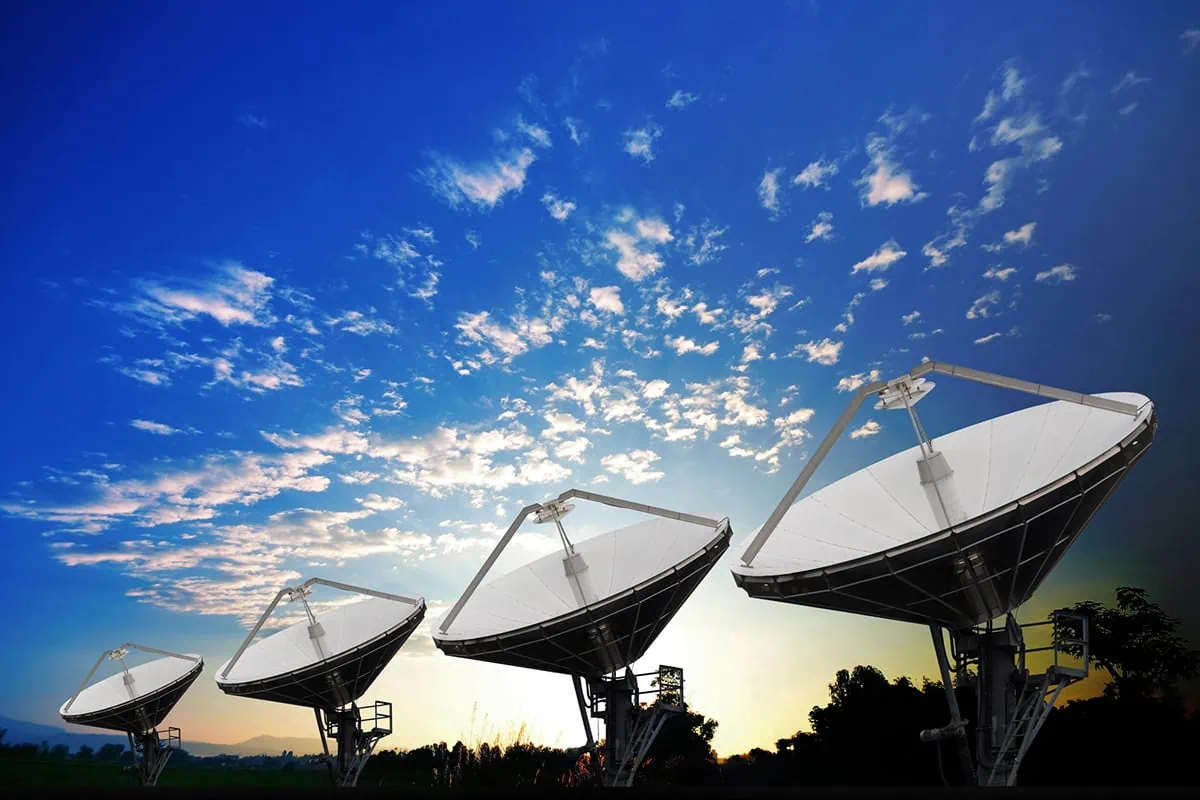 7 Space ETFs for the Next Frontier of Investing 6 Several satellite dishes against a blue sky.