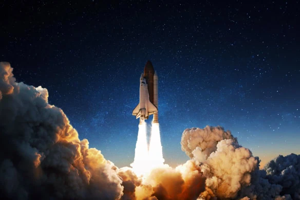A launch of a space shuttle against a starry sky.