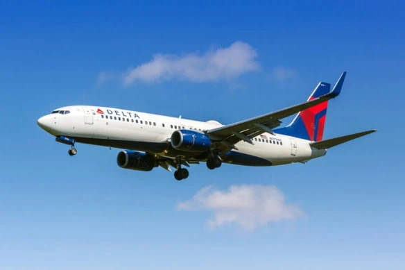 a delta air lines plane in the sky.