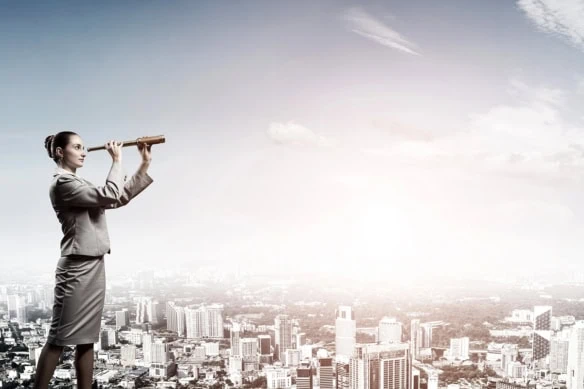 a businesswoman looks out with a spyglass.