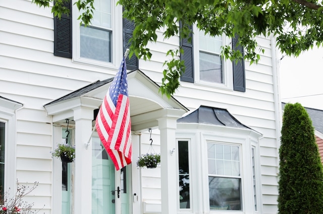 american flag hanging on front of house