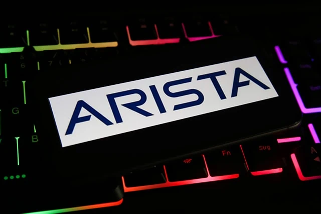 A darkly lit keyboard with the Arista Networks logo over it.