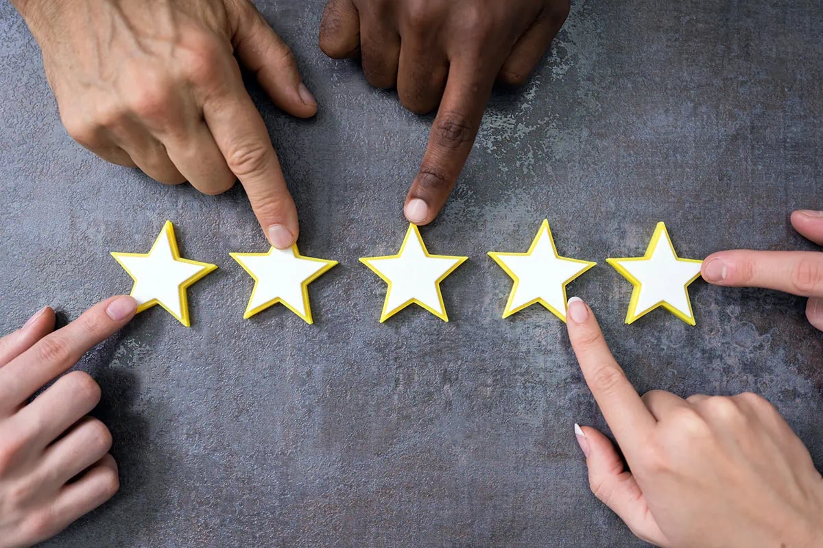 Wall Street Loves These 10 Dividend-Growth Stocks 4 many hands pointing to a five star rating.
