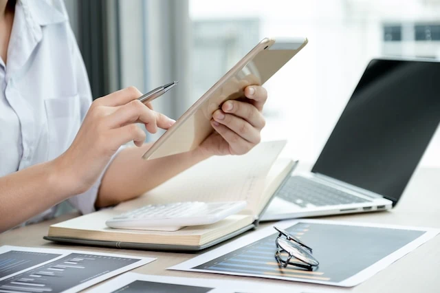 businesswomen bookkeeper use tablet and laptop doing account