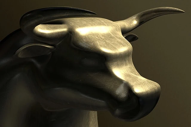 HSBC, Yardeni Add to Growing Stack of S&P 500 Upgrades 2 A closeup of a bronze casting depicting a stylized bull in contrasting light on an isolated dark background.