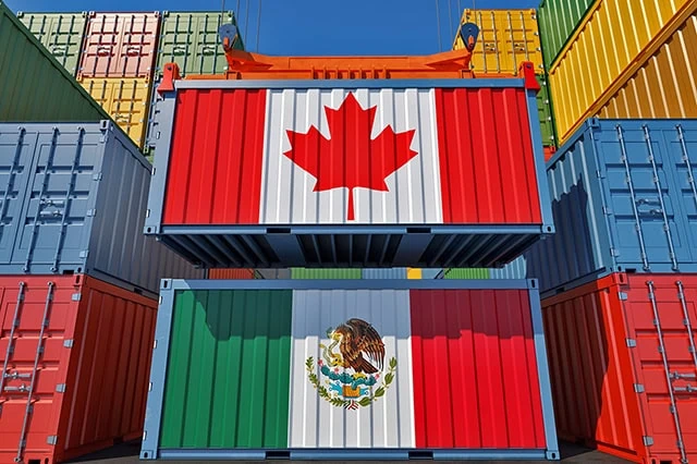 a shipping container with a canadian flag above another shipping container with a mexican flag.