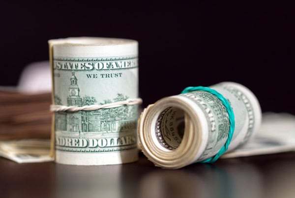 two rolls of hundred dollar bills.