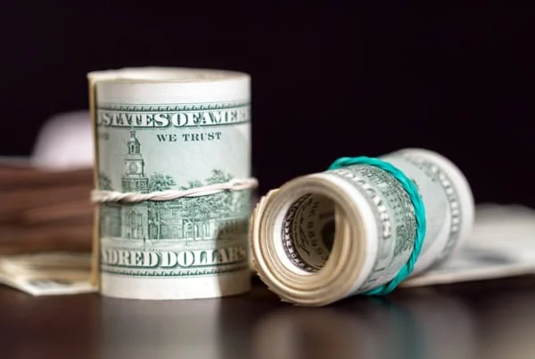 two rolls of hundred dollar bills.