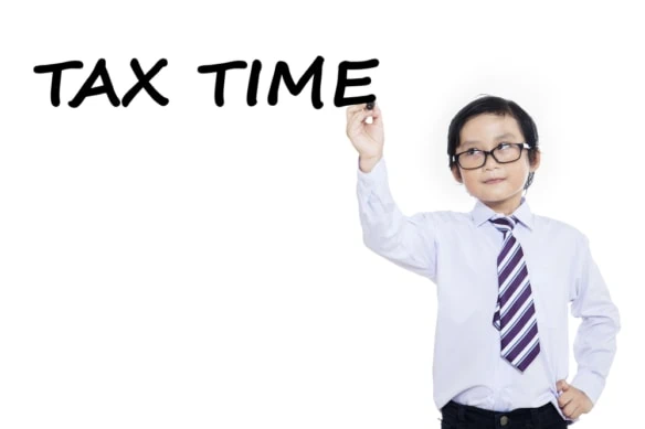 Little boy writes tax time