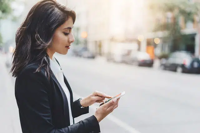 confident young woman on smartphone