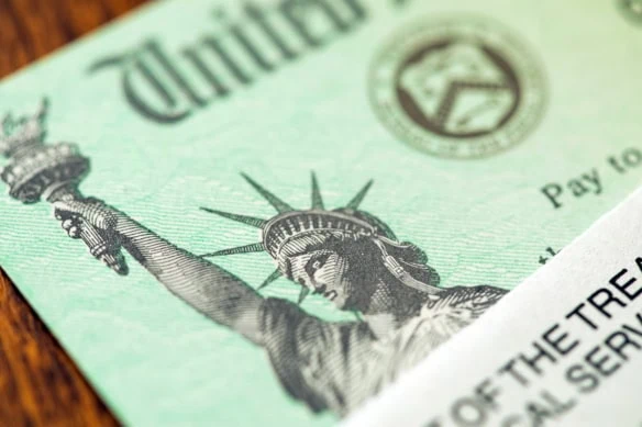 2026 COLA: Here's How Much Your Social Security Benefits Will Rise 1 a united states treasury check.