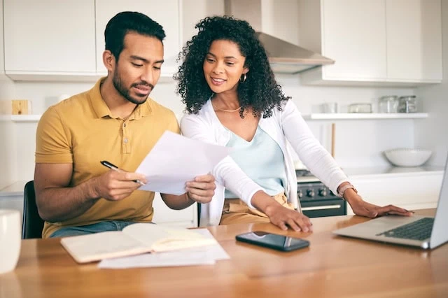 couple looking at finances together 640