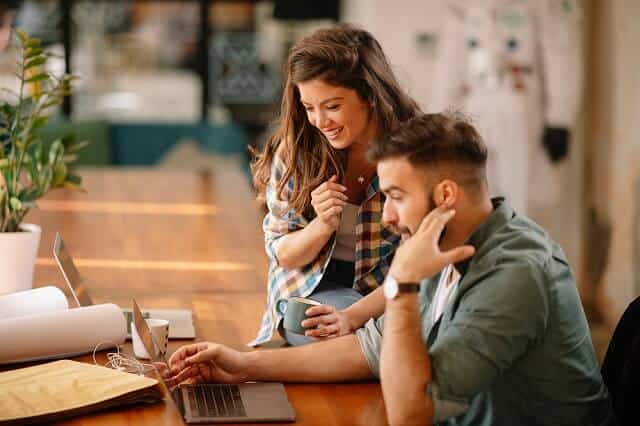 couple reviewing information on computer medium