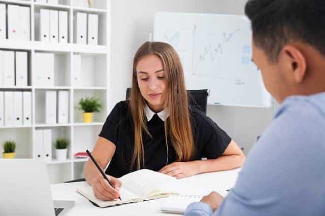 coworkers taking notes and working together 1