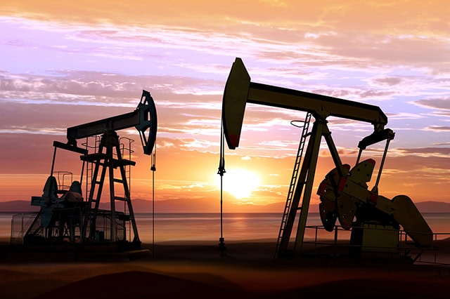 The Best Dividend Stocks: 10 Pro-Grade Income Picks for 2025 15 the silhouettes of oil rings against a sunset.