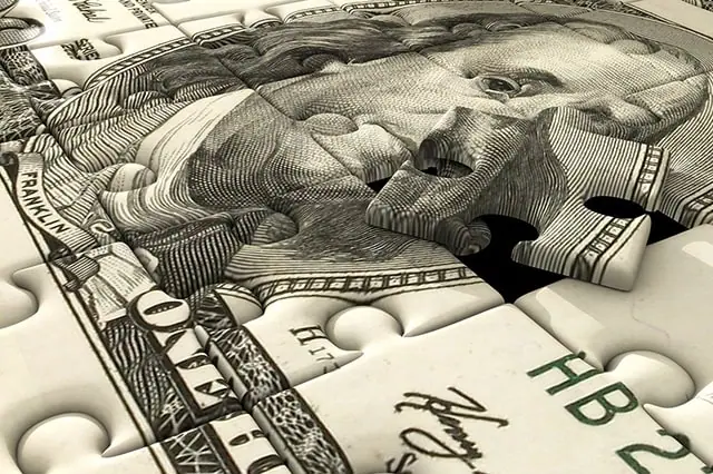 How to Teach Kids About Money Management: Budget, Save + Spend 3 a dollar bill is cut into puzzle pieces.