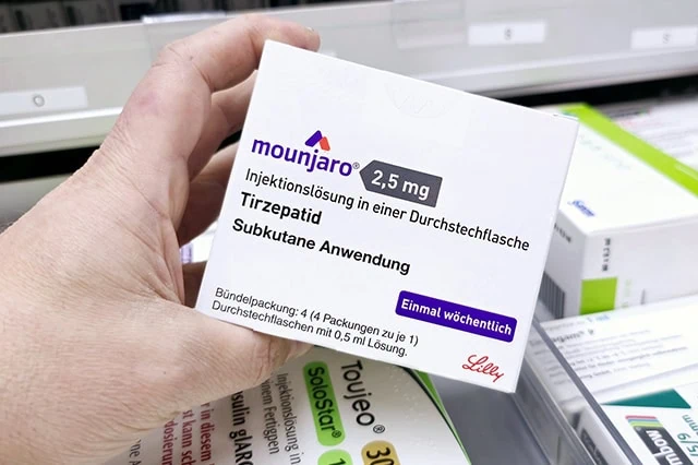 15 Best Long-Term Stocks to Buy and Hold Forever 9 a pharmacist holds a box of mounjaro by eli lilly.