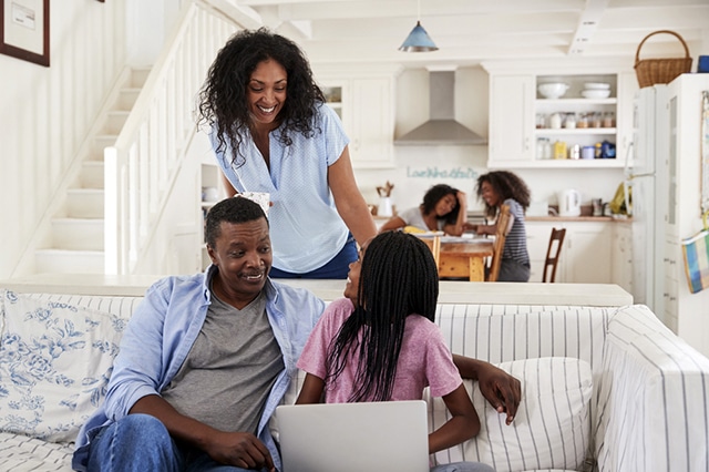 family with teen daughter laptop