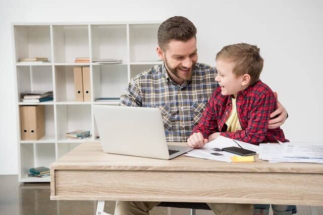 father and son at computer happy medium