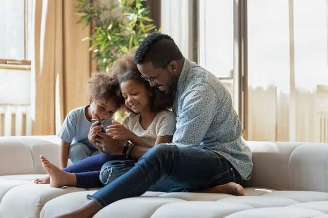 father with children on smartphone medium