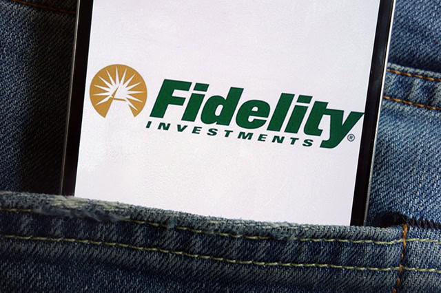 a smartphone in a persons rear jeans pocket has the fidelity logo on it.