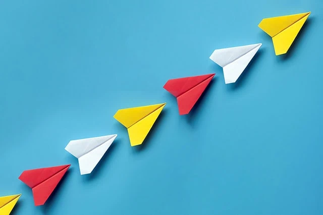 7 Best Growth Stocks to Buy for the Rest of 2026 8 a line of paper airplanes that are flying up and to the right.
