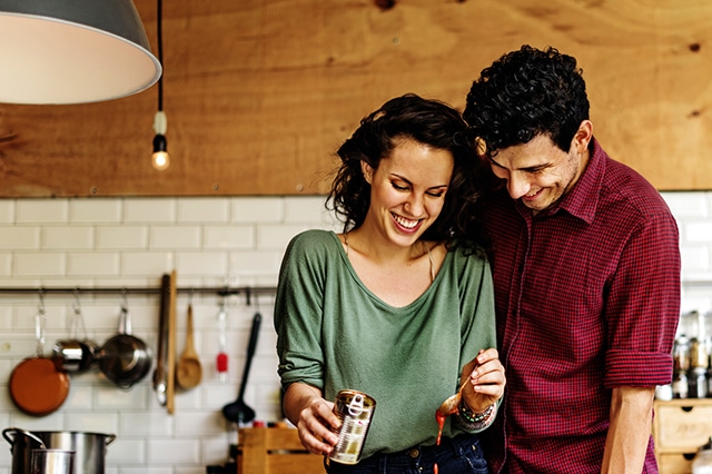 happy couple cooking kitchen