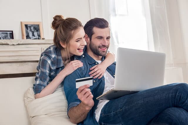 happy couple holding a card