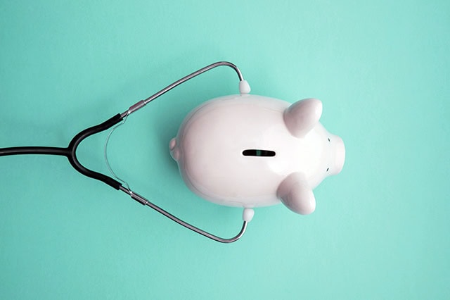 piggy bank with stethoscope.