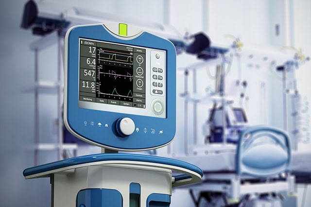 Medical ventilator device in hospital room.