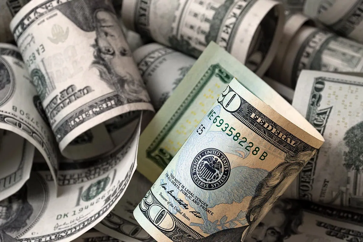 The 16 Best ETFs to Buy for a Prosperous 2026 17 several rolled up twenty dollar bills.