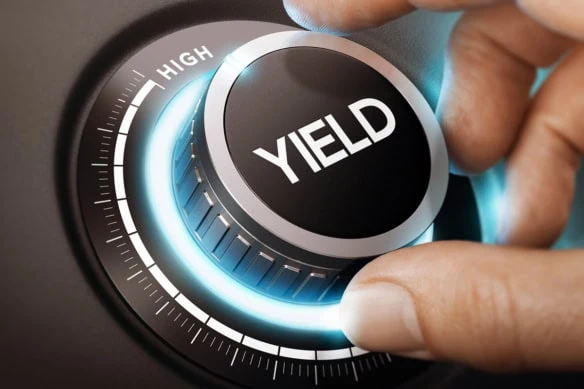 A person turns a knob to select high yield investment.
