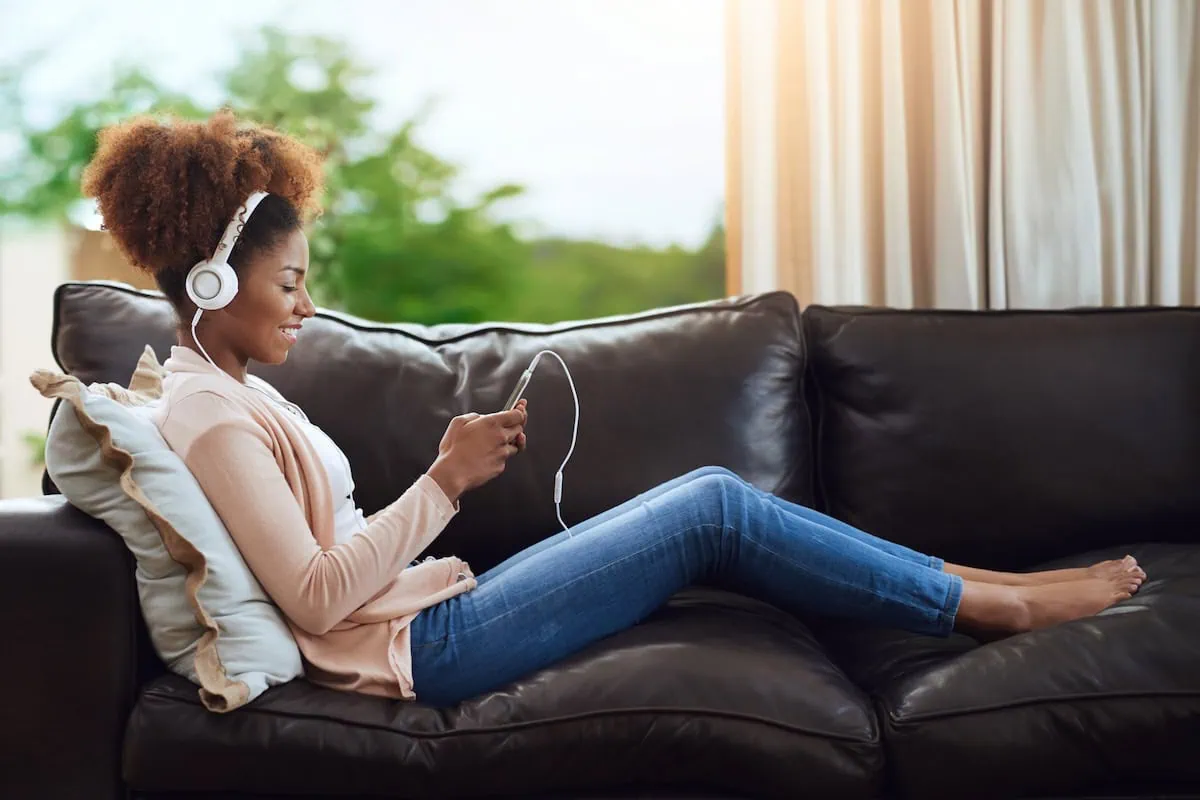 12 Easy Ways to Lower Your Gas Costs 3 house sitting couch hustle headphones teen 1200