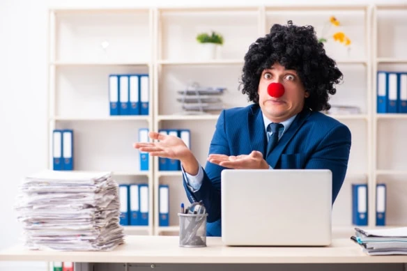 Young clown businessman working in the office