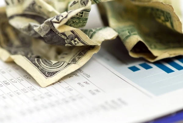 a crumpled dollar bill on top of data.