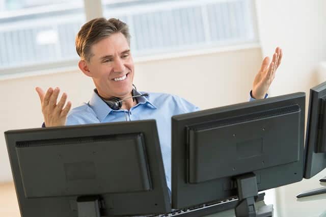 investor looking at monitors medium