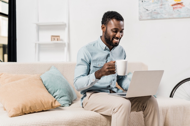 man coffee laptop sitting online