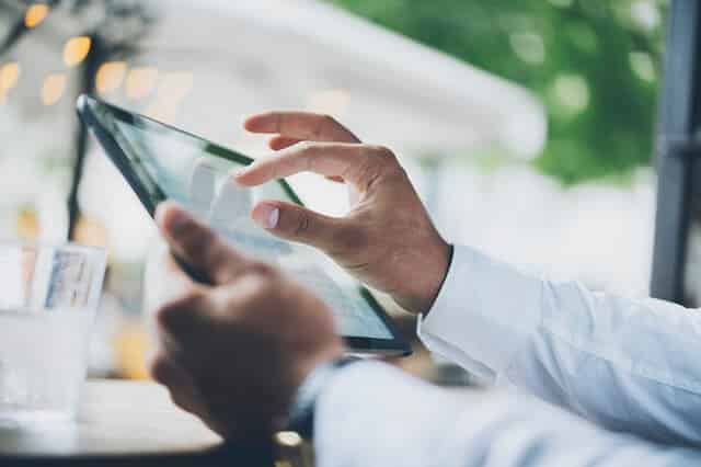 man looking at tablet for information 1