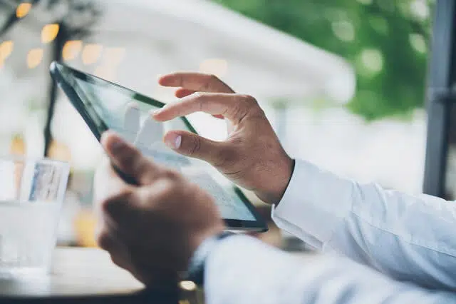 man looking at tablet for information