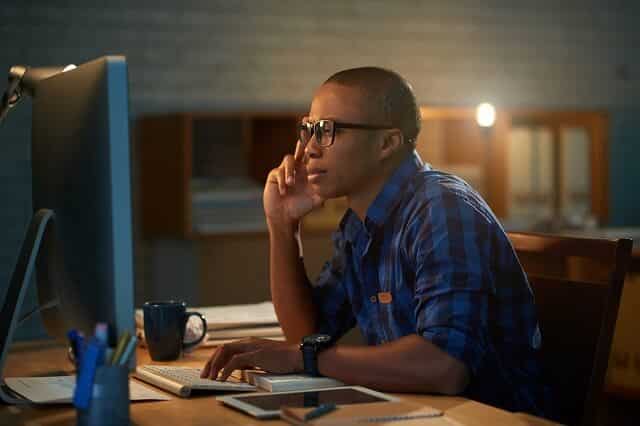 man looking intently at computer screen