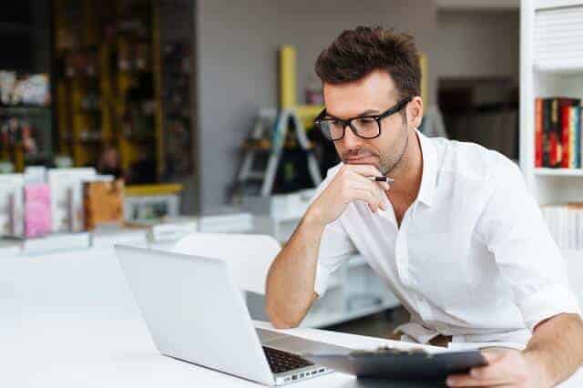 man reviewing financial information on computer 1